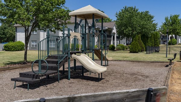 Colorful playground at The Weathersby at Station Circle Apartments featuring slides and swings for family fun