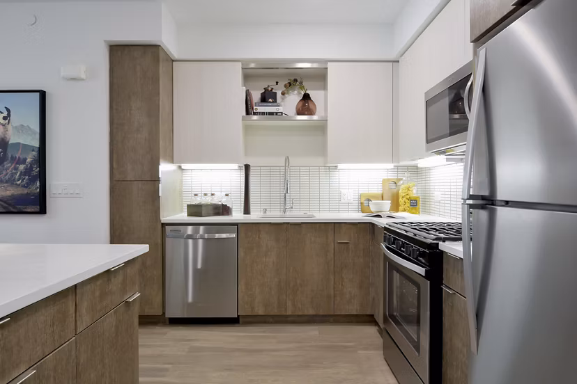 Sleek modern kitchen with stainless steel appliances at The Martin Apartments, luxury living in the heart of the city