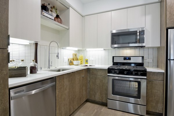 Modern kitchen with stainless steel appliances at The Martin Apartments in Seattle