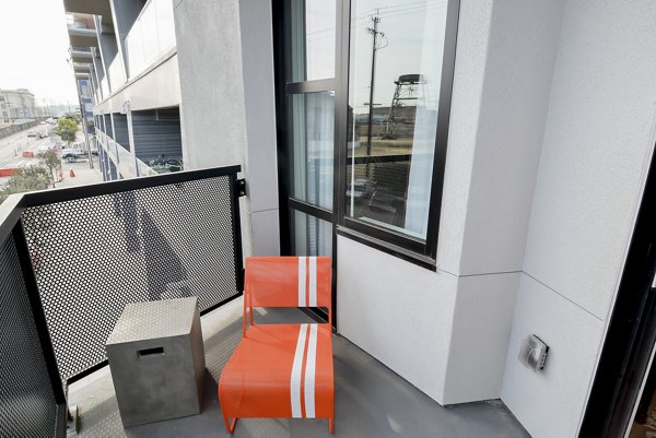 The Martin Apartments: Contemporary patio with seating and city views, a luxury living space in vibrant urban landscape