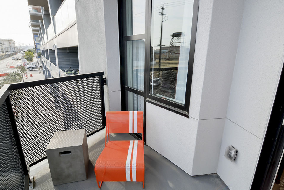 The Martin Apartments: Contemporary patio with seating and city views, a luxury living space in vibrant urban landscape