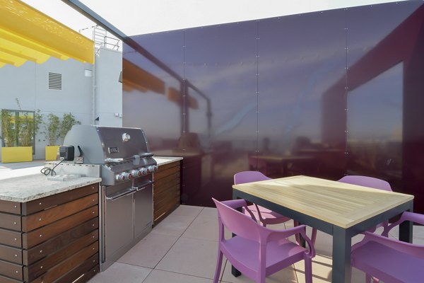 Rooftop patio with stylish seating and skyline views at The Martin Apartments
