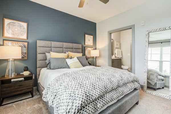 Stylish bedroom with chic decor at Element Barclay Apartments, featuring luxe bedding and modern furniture