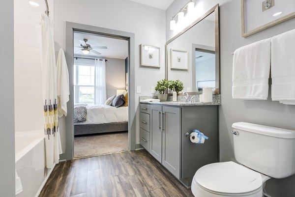 Modern bathroom featuring sleek fixtures and bright lighting at Element Barclay Apartments