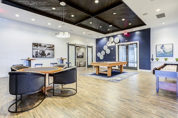 Modern clubhouse with lounge seating and fireplace at Element Barclay Apartments