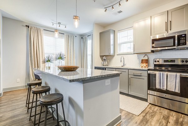Modern kitchen with stainless steel appliances at Element Barclay Apartments offering luxury living spaces