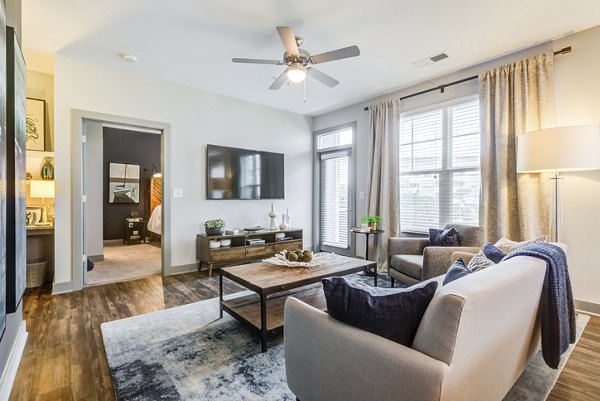 Living room featuring modern decor and ample natural light at Element Barclay Apartments