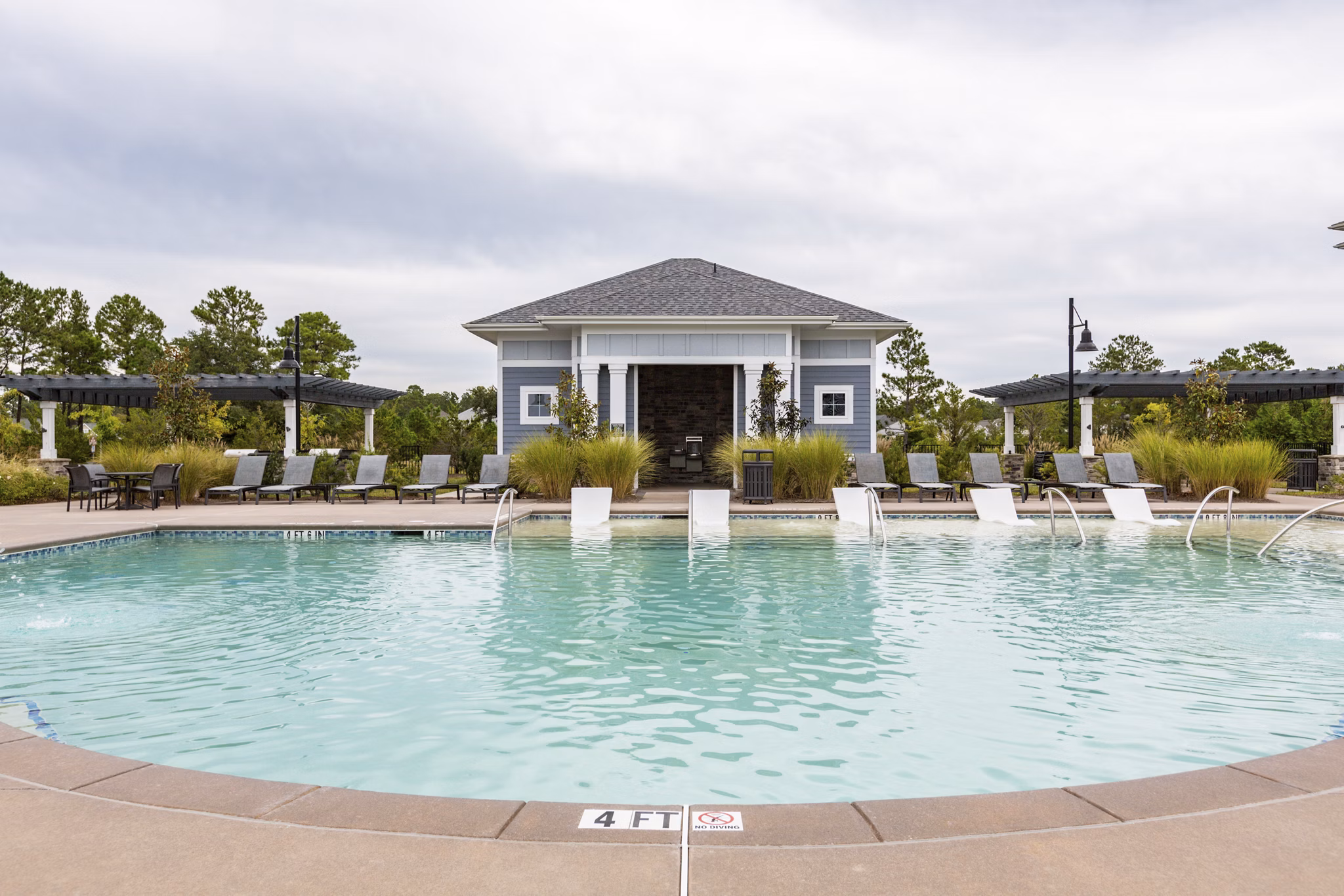 Refreshing outdoor pool at Element Barclay Apartments, perfect for relaxing and enjoying the luxury setting