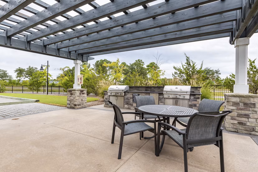 Outdoor grill area with modern seating at Element Barclay Apartments