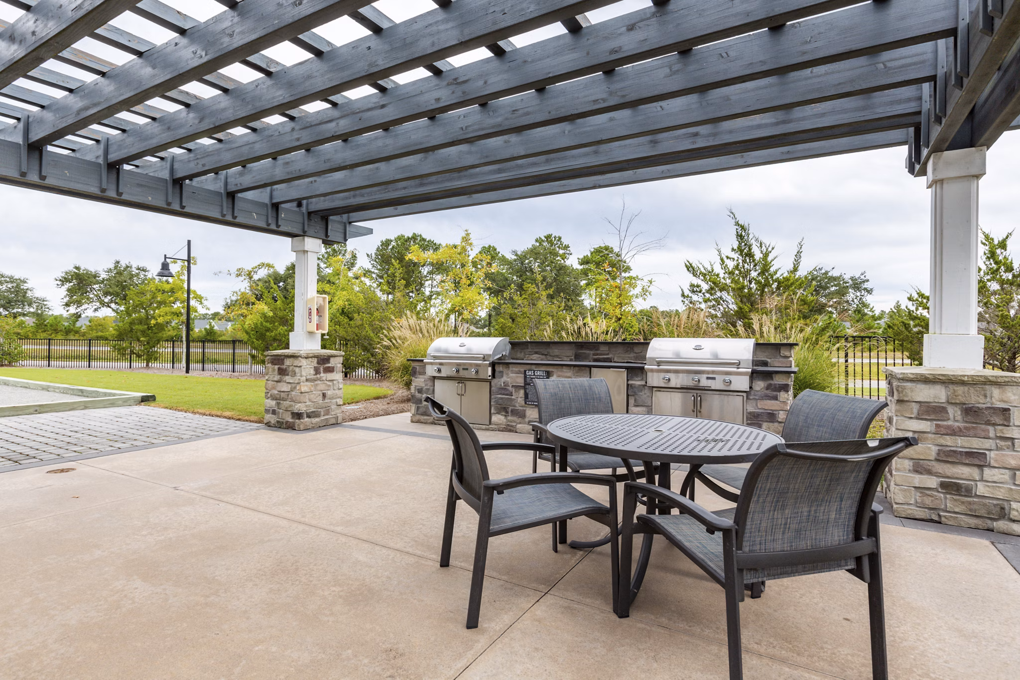 Outdoor grill area with modern seating at Element Barclay Apartments
