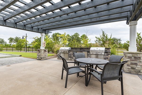 Outdoor grill area with modern seating at Element Barclay Apartments