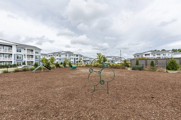 Dog park with agility equipment at Element Barclay Apartments