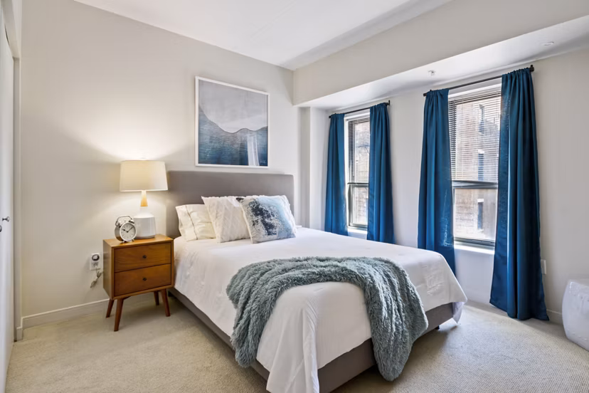 Cozy bedroom with modern furnishings at James and Harrison Court Apartments