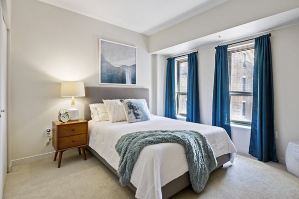 Cozy bedroom with modern furnishings at James and Harrison Court Apartments