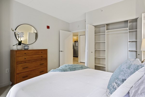 Elegant bedroom with plush bedding and stylish dÃ©cor at James and Harrison Court Apartments