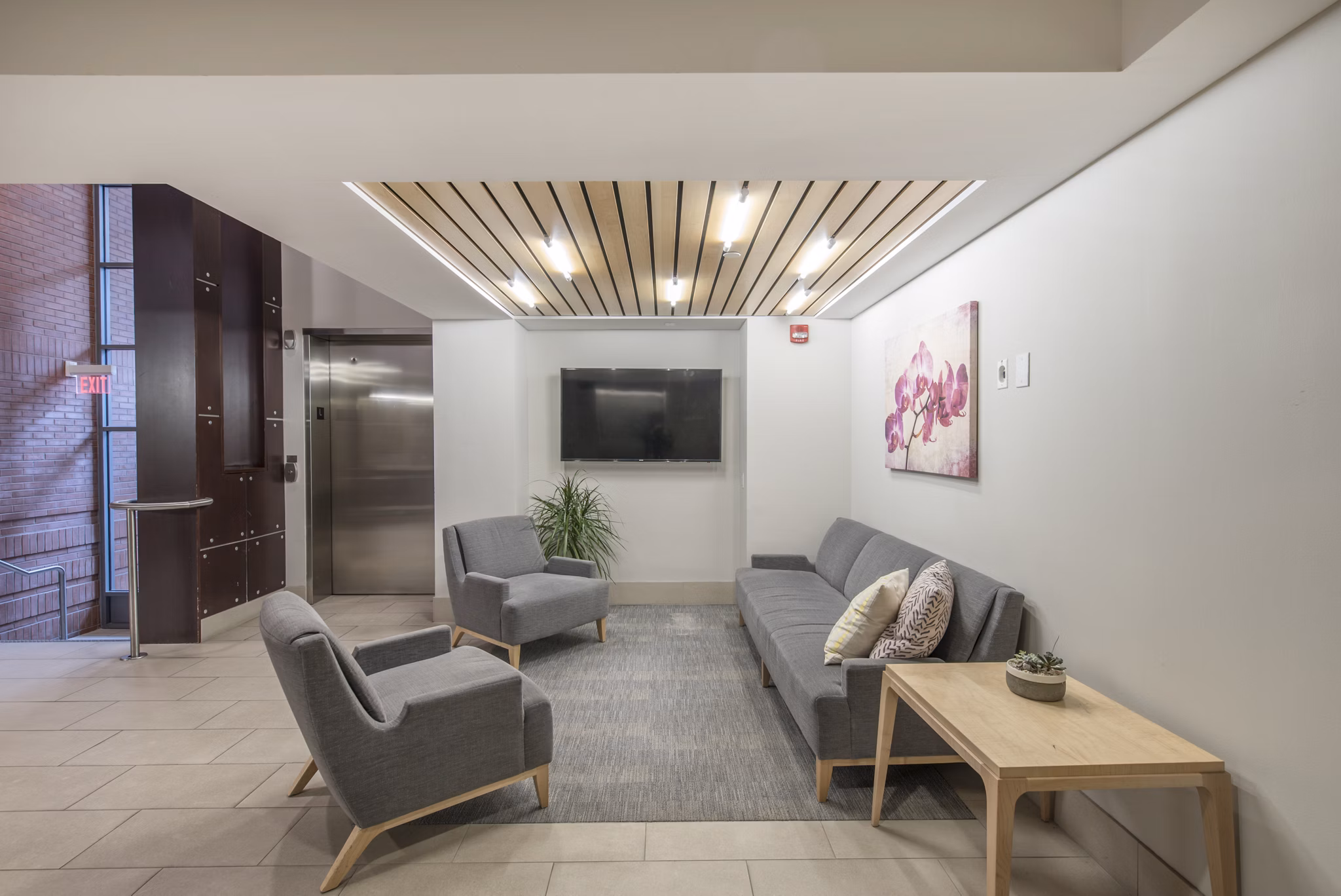 Elegant clubhouse with multiple seating areas at James and Harrison Court Apartments, perfect for community gatherings and social events