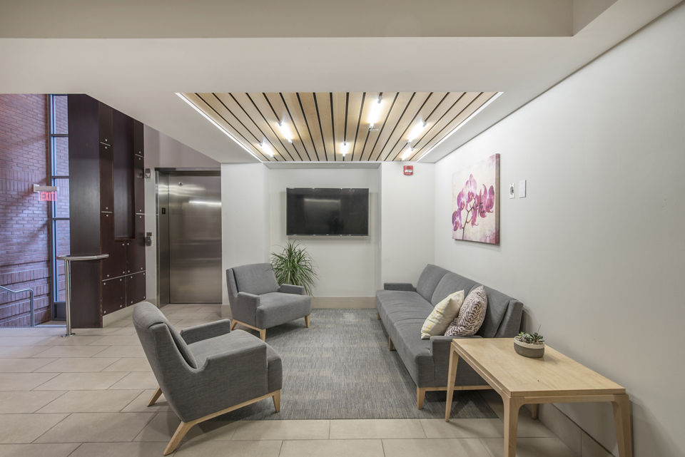 Elegant clubhouse with multiple seating areas at James and Harrison Court Apartments, perfect for community gatherings and social events