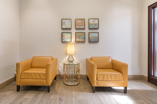 Clubhouse featuring modern design and plush seating at James and Harrison Court Apartments