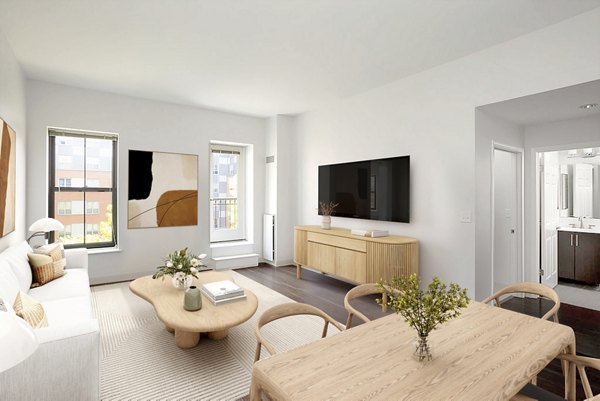 Dining area featuring modern furnishings and elegant lighting in James and Harrison Court Apartments, a Greystar community