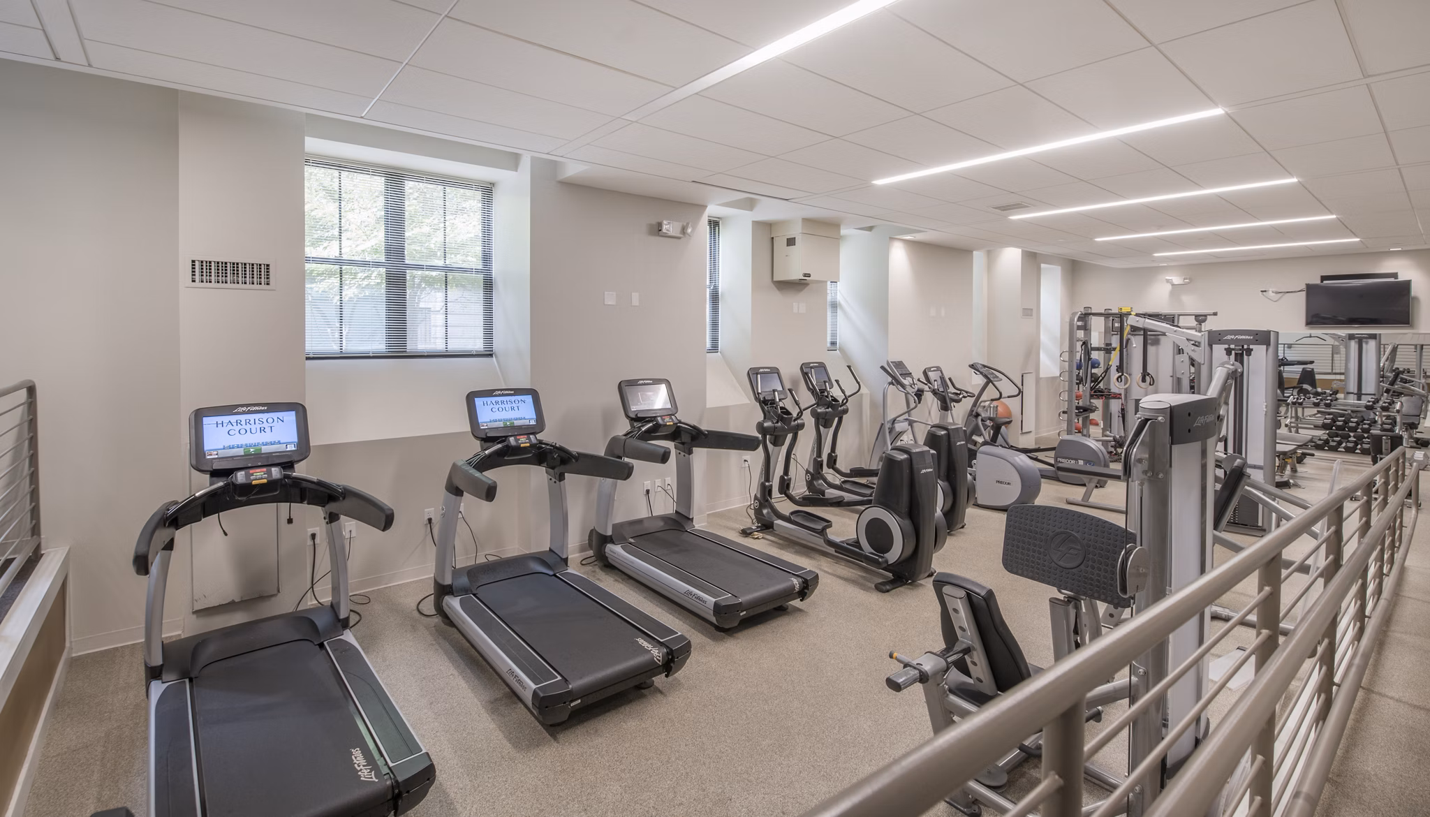 Modern fitness center with state-of-the-art equipment at James and Harrison Court Apartments