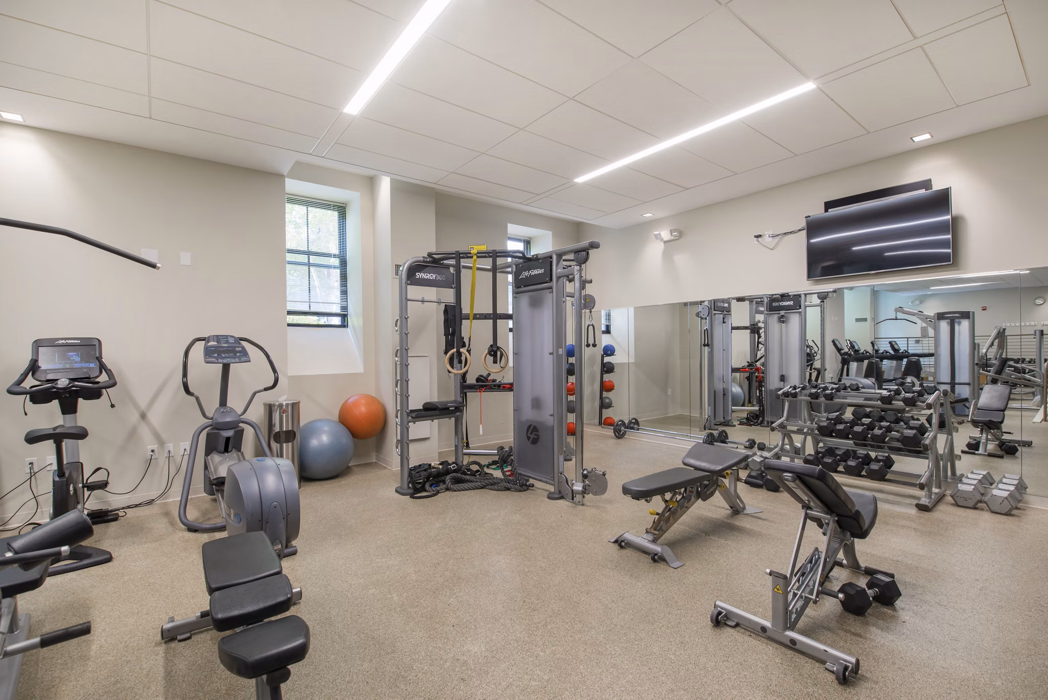 Modern fitness center with state-of-the-art equipment at James and Harrison Court Apartments