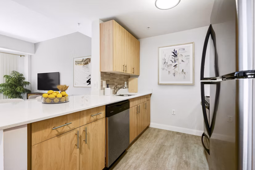 Modern kitchen featuring stainless steel appliances at James and Harrison Court Apartments