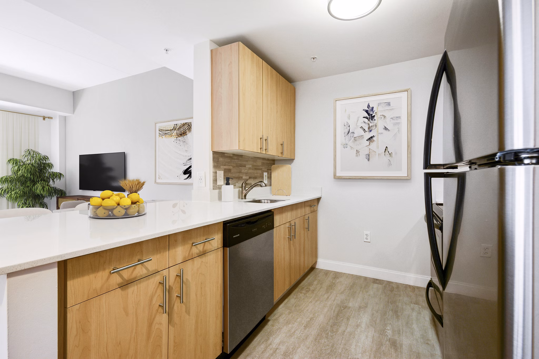 Modern kitchen featuring stainless steel appliances at James and Harrison Court Apartments