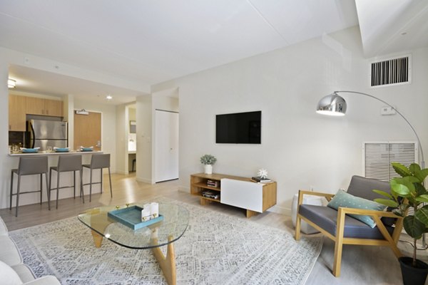 Spacious living room with modern decor and hardwood floors at James and Harrison Court Apartments