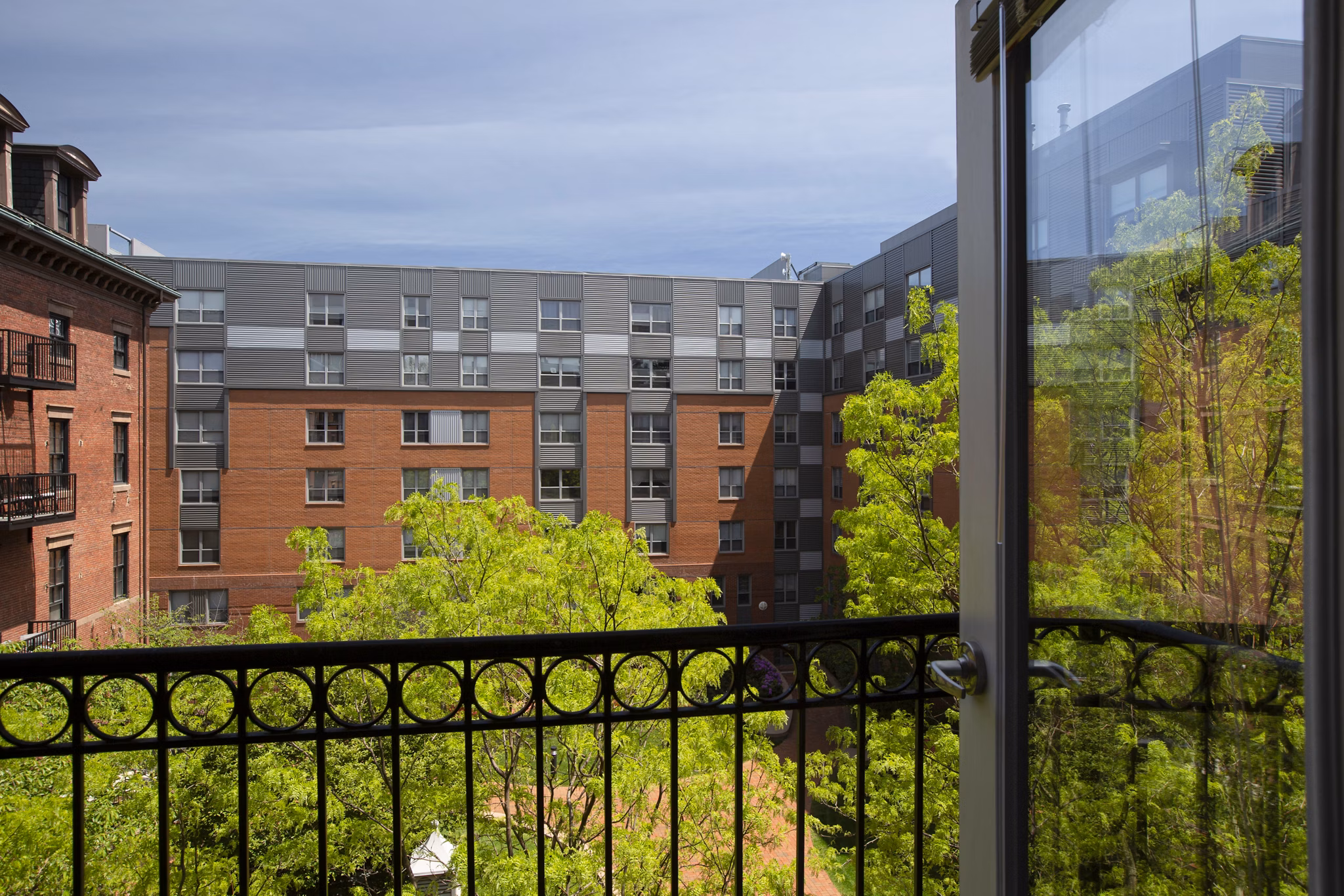 Modern outdoor patio with seating at James and Harrison Court Apartments, perfect for relaxation and social gatherings in a luxury setting