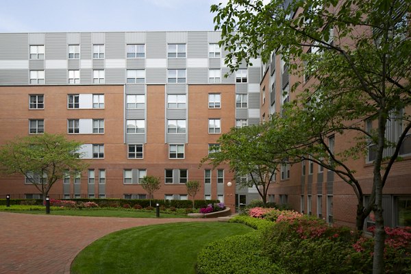 Courtyard at James and Harrison Court Apartments featuring lush landscaping and outdoor seating areas