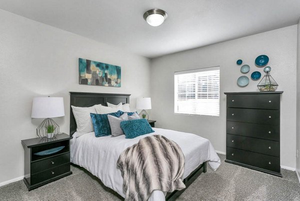 Cozy bedroom with elegant design and natural light at Magnolia Ridge Apartments
