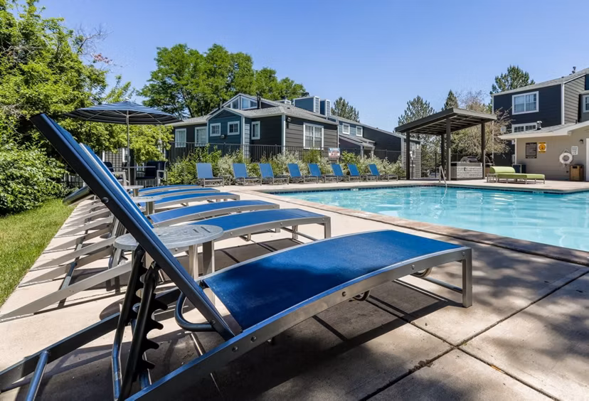 Relaxing pool area at Magnolia Ridge Apartments with lush landscaping and seating areas for a leisurely experience