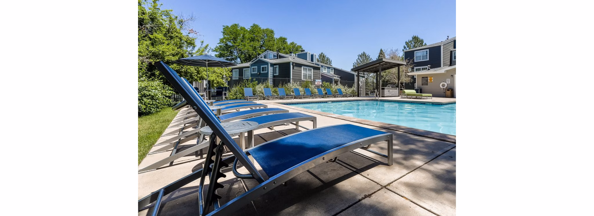 Relaxing pool area at Magnolia Ridge Apartments with lush landscaping and seating areas for a leisurely experience