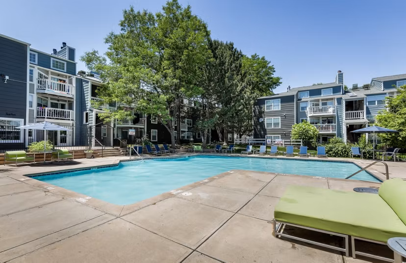 Luxurious outdoor pool area surrounded by lush greenery at Magnolia Ridge Apartments