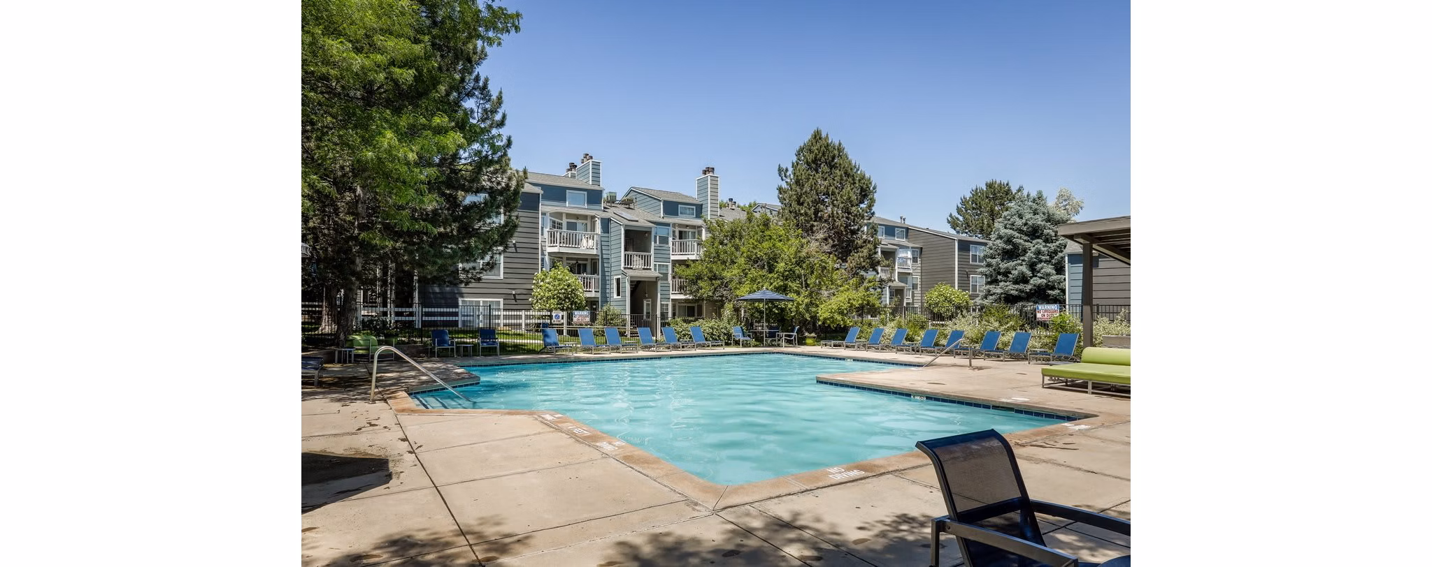 Swimming pool with lounge chairs at Magnolia Ridge Apartments, a luxury property managed by Greystar, offering a relaxing environment