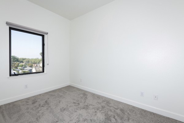 Cozy bedroom with modern decor in 1122 U Apartments in downtown, perfect for luxury living