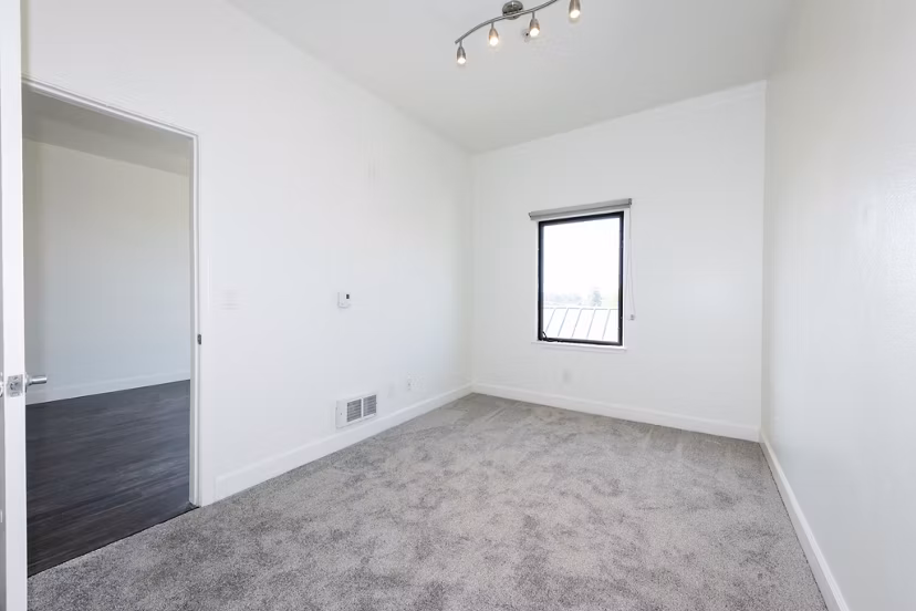 Bedroom featuring modern decor and large windows at 1122 U Apartments, a luxury living space ideal for comfort and style