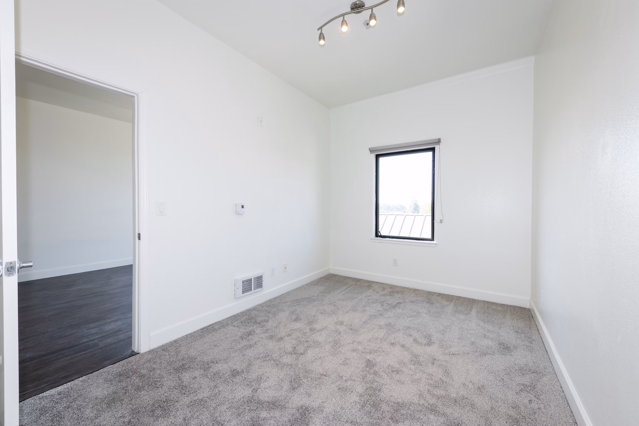 Bedroom featuring modern decor and large windows at 1122 U Apartments, a luxury living space ideal for comfort and style