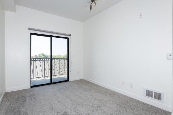 Bedroom featuring modern decor and ample natural light at 1122 U Apartments, a Greystar luxury property