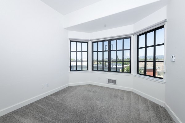Elegant bedroom with modern furnishings at 1122 U Apartments, showcasing comfort and style in Greystar luxury apartments