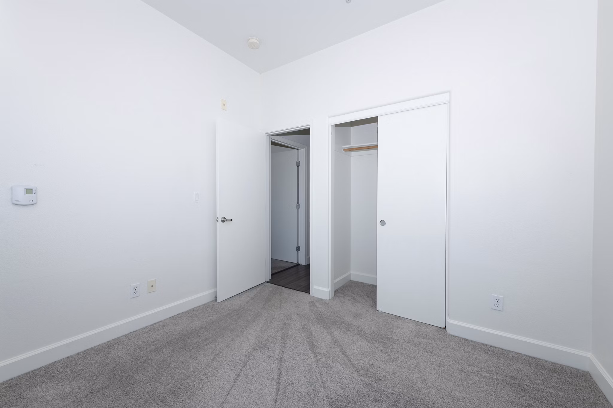 Cozy bedroom with plush bedding at 1122 U Apartments, a luxury Greystar community