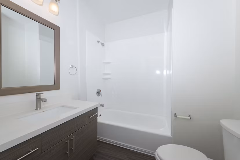 Bathroom featuring sleek fixtures and marble countertops in 1122 U Apartments