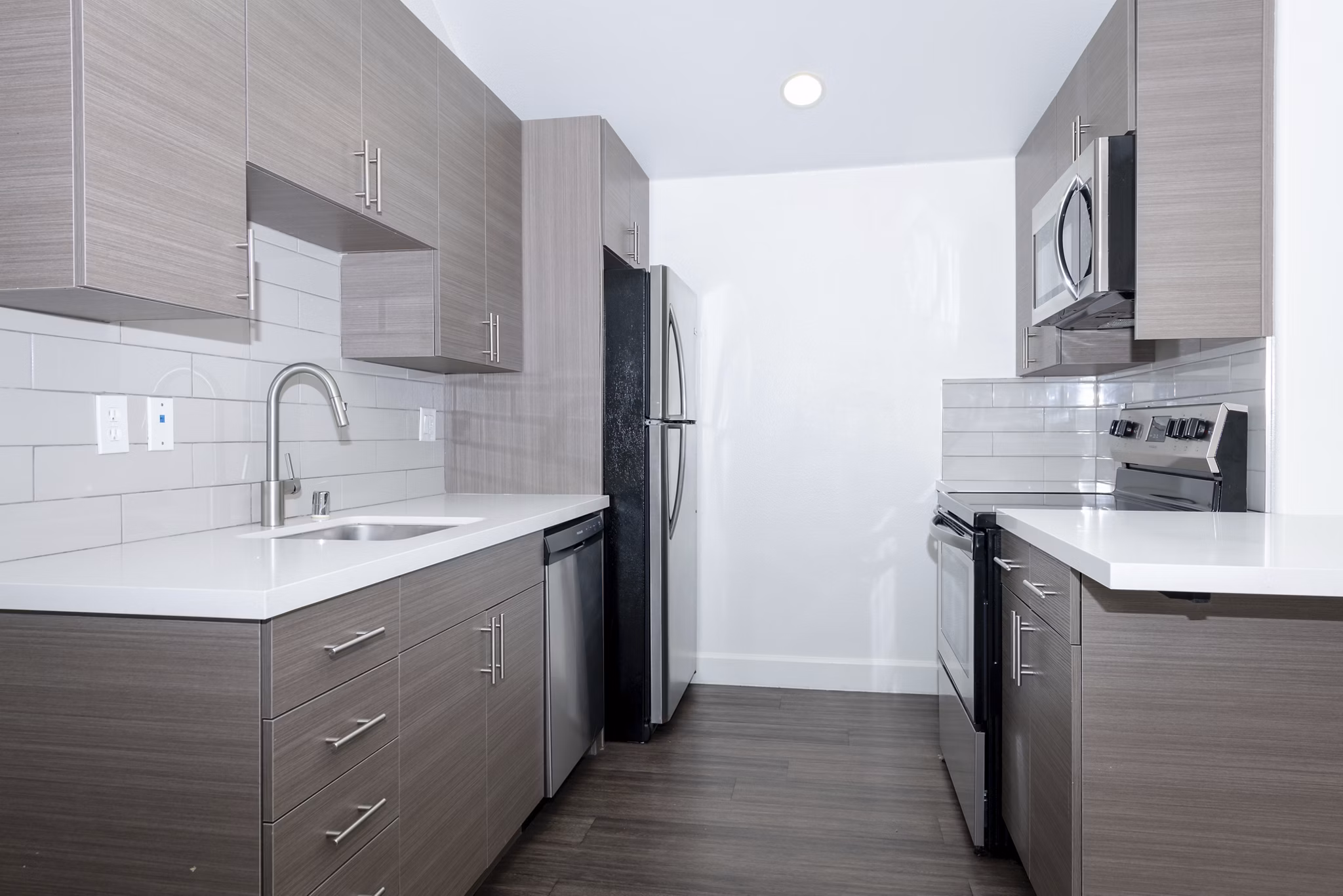 Modern kitchen with stainless steel appliances at 1122 U Apartments, offering luxury living in the heart of the city
