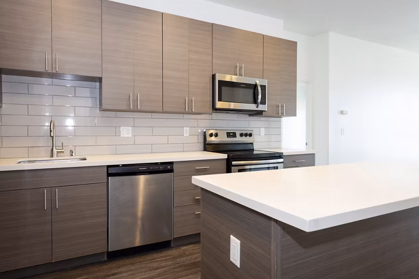 Modern kitchen with stainless steel appliances at 1122 U Apartments