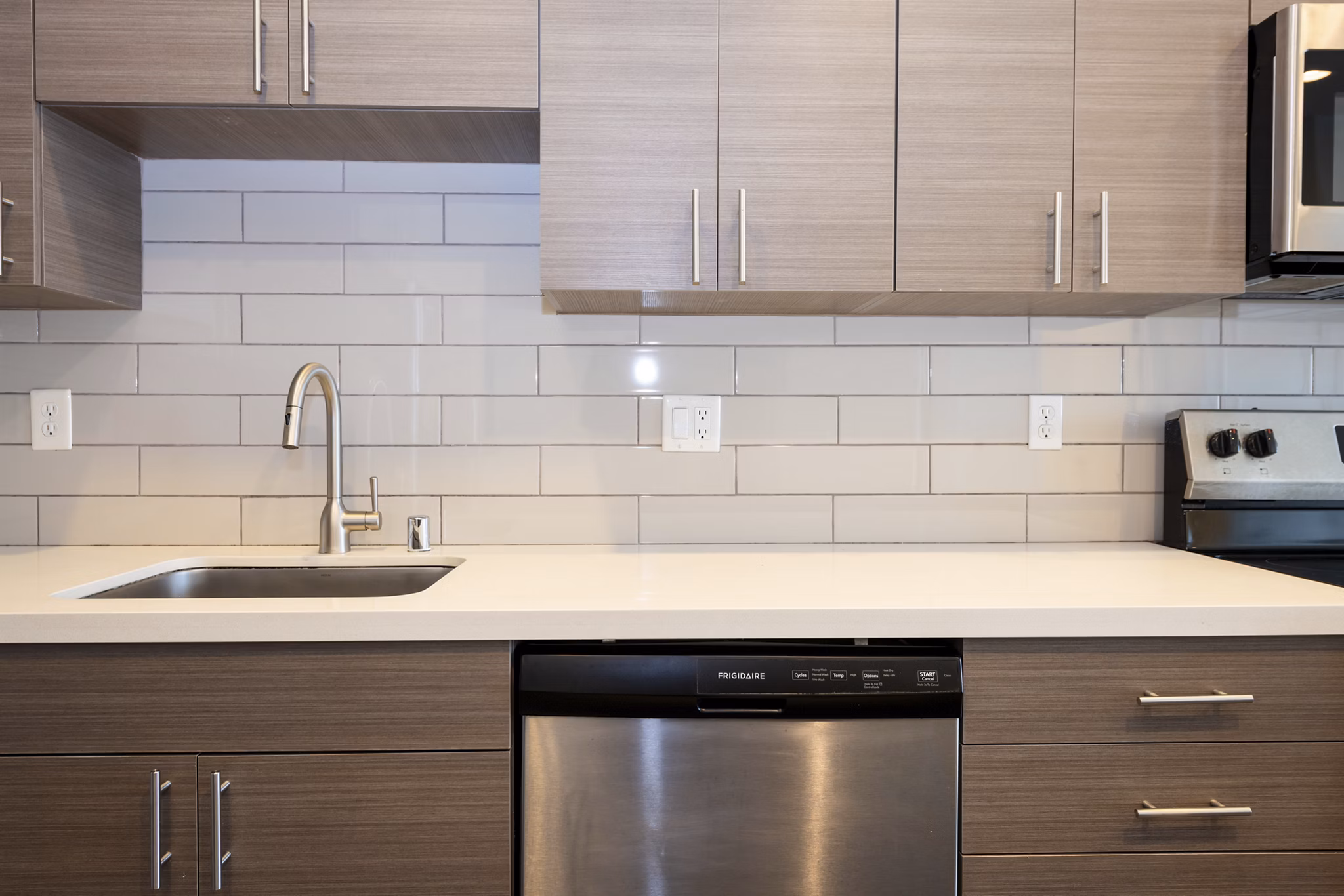 Modern kitchen with stainless steel appliances at 1122 U Apartments