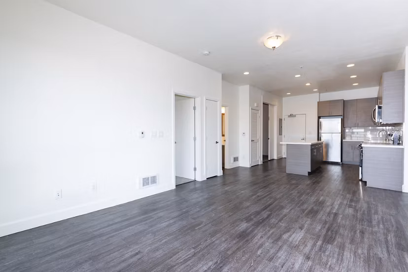 Stylish living room with modern furnishings and ample natural light at 1122 U Apartments