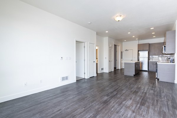 Stylish living room with modern furnishings and ample natural light at 1122 U Apartments
