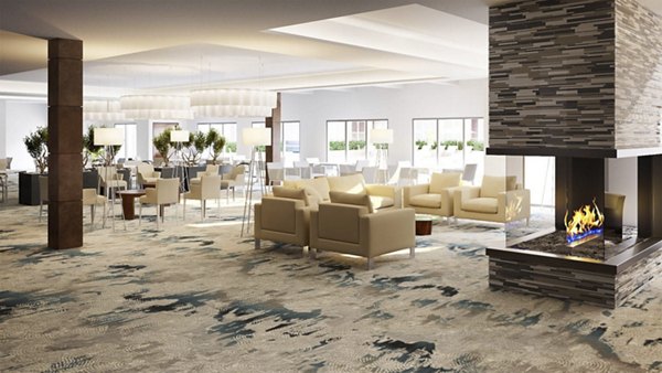 Modern lounge area with comfortable seating and fireplace in luxury apartment community