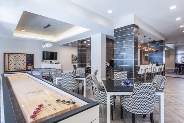 Vibrant game room featuring billiards and arcade games at Overture Domain luxury apartments