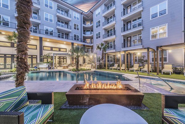 Resort-style pool surrounded by lush greenery at Overture Domain luxury apartments